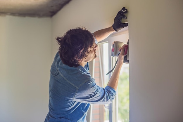 Man in a blue shirt does window installation.