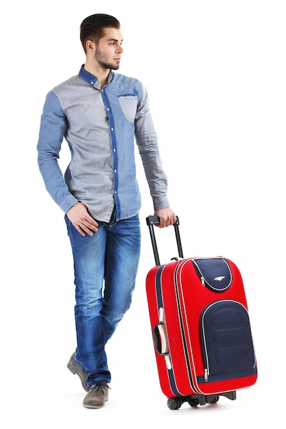 Человек в синей рубашке и джинсах с чемоданом, изолированным на белом