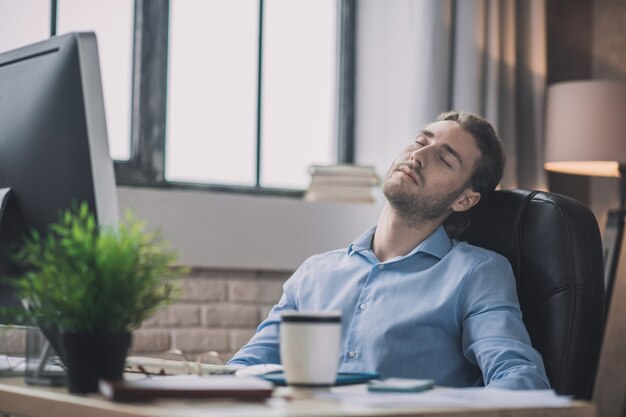 Man in blue shirt looking tired