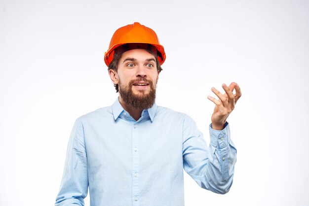 Man in blue shirt orange hard hat professional construction safety engineer High quality photo