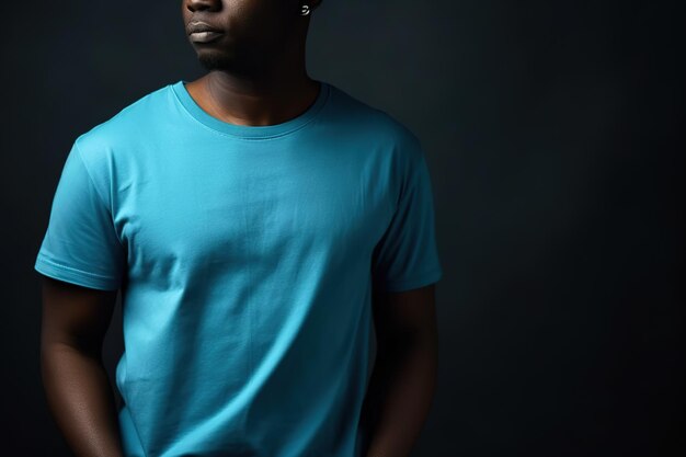 A man in a blue shirt stands in a dark room.