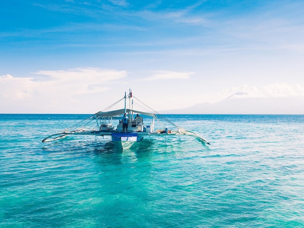 Man on boat at sea against sky