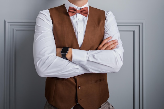 Man in bow tie and vest in the room