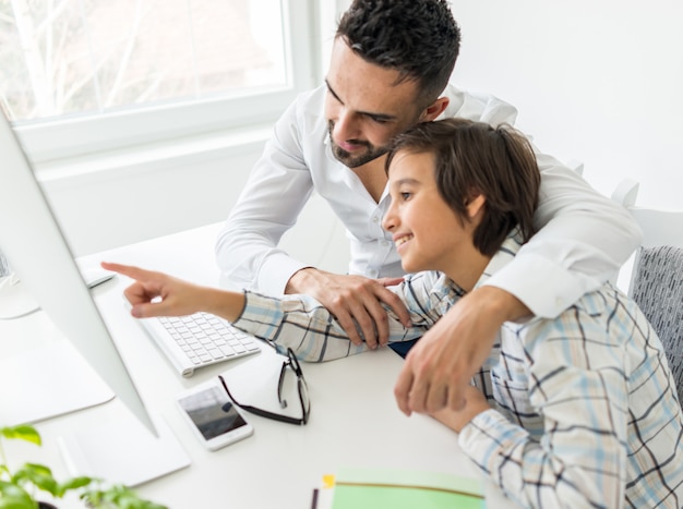 Man and boy on computer