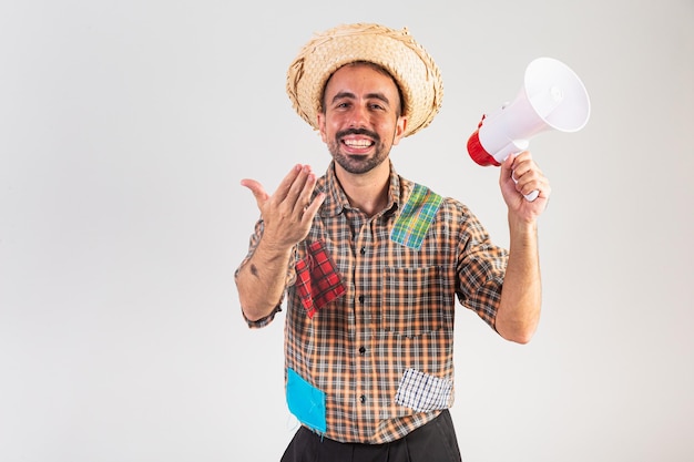 Man brazilian wearing festa junina clothes Arraial Feast of Saint John shouting promotion with megaphone