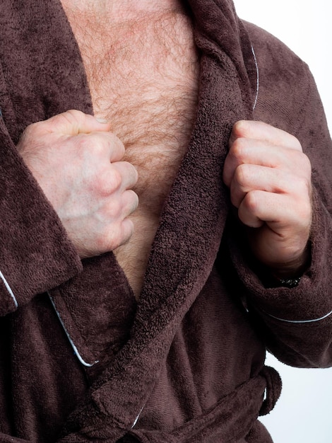 Man in a bright bath robe advertises clothing details on an isolated white background