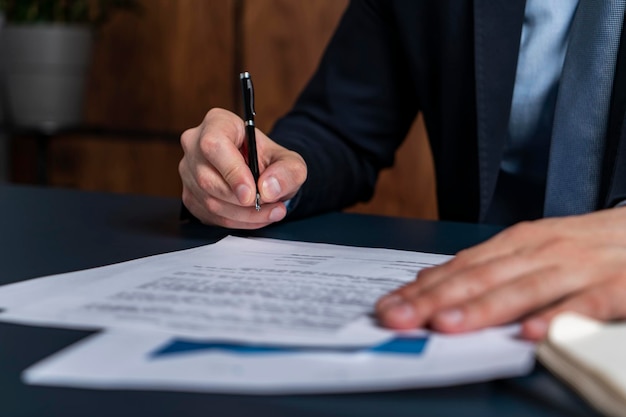 A man broker signing the mortgage contract at the real property agent office The concept of entering into legal power to take liabilities