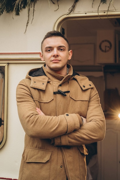 man in brown jacket near the trailer