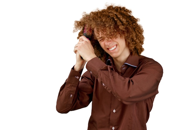 man in a brown shirt uses a wooden comb