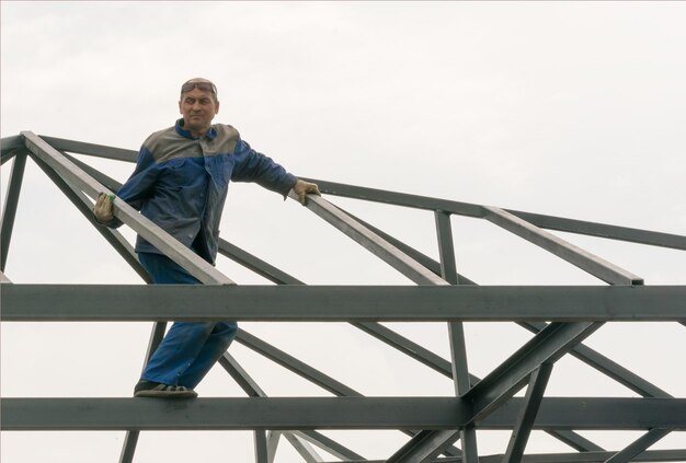 Man builder at the top of the metal structure