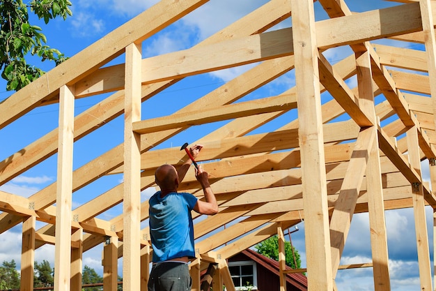 Photo a man builds a house in the village