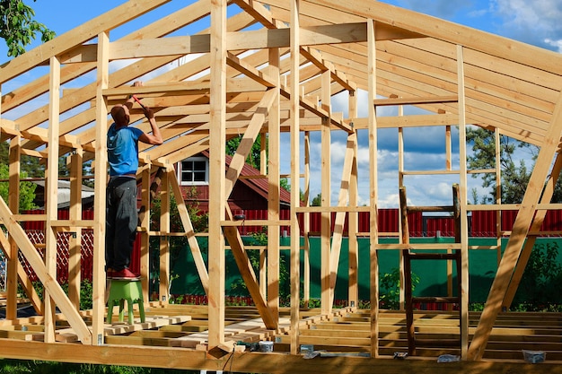 Photo a man builds a house in the village