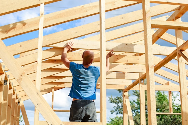 A man builds a house in the village