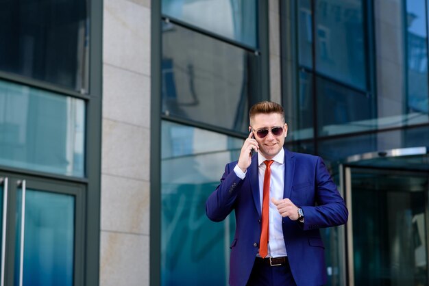 A man business man talking on the phone on the street