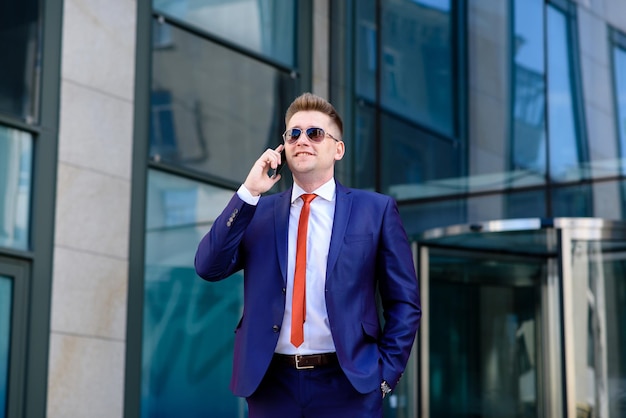 A man business man talking on the phone on the street