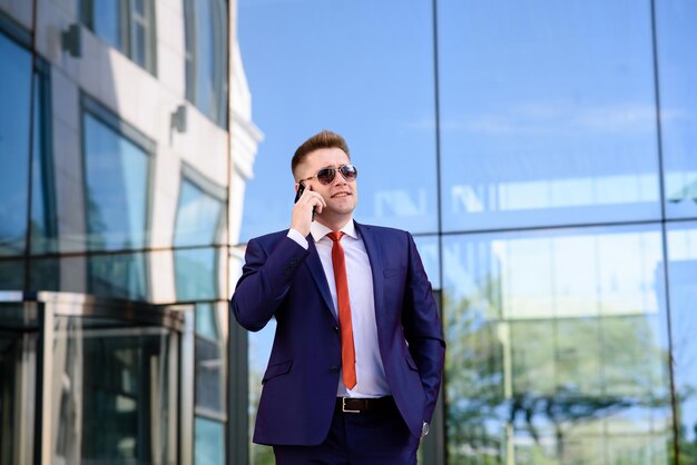 A man business man talking on the phone on the street