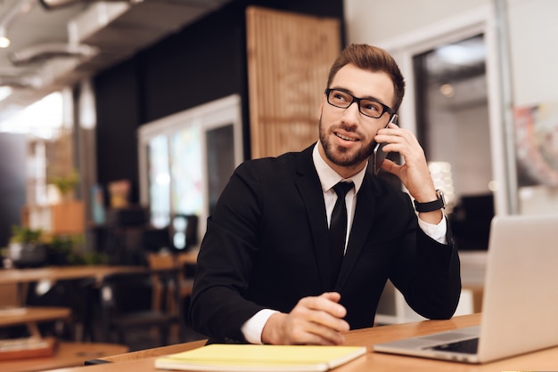 A man in a business suit is working in his office.