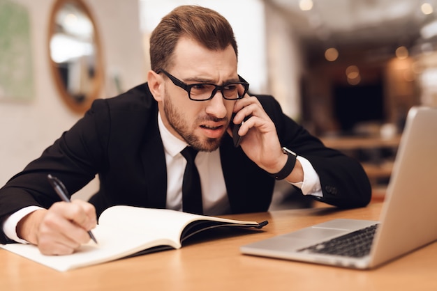 A man in a business suit is working in his office.