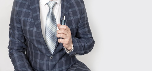 Man businessman smoking ecigarette wearing a formal blue suit on a white background