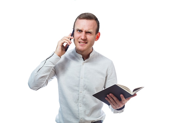 Man businessman, teacher, mentor examines entries in your diary and talking on a cell phone. Isolated on white background