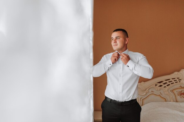 a man and a buttondown shirt clothing for interviews work and corporate fashion for business The hands of a male person the groom is preparing for the wedding