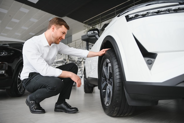 Man buying a car at a showroom