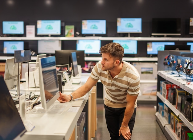 Photo man buying monitor in mall