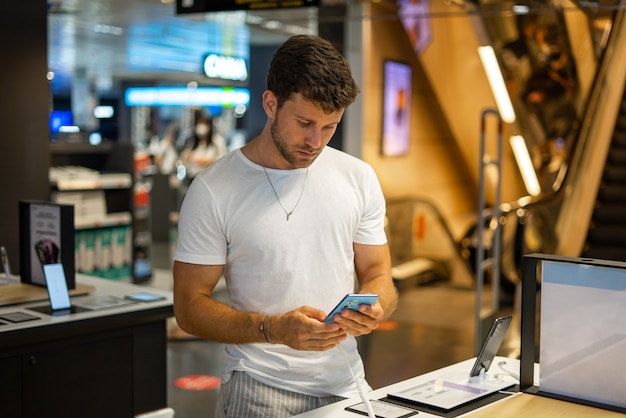 Man buying new gadget in store