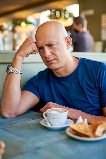 Man in a cafe at breakfast