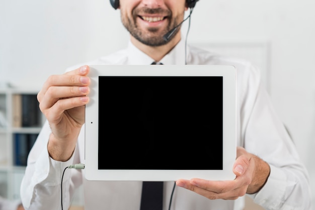 Man in call center showing tablet