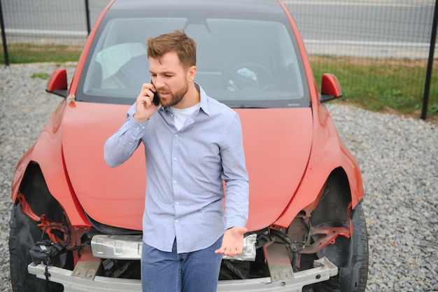 Photo man calling help after a car crash accident on the road