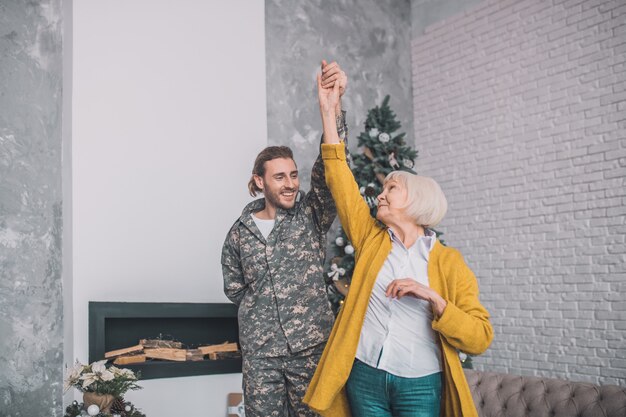 Man in camouflage and his mom feeling happy