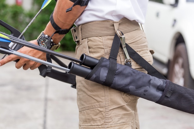 Man in cargo pants with bow and arrows