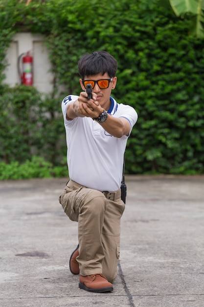 Man in cargo pants with gun