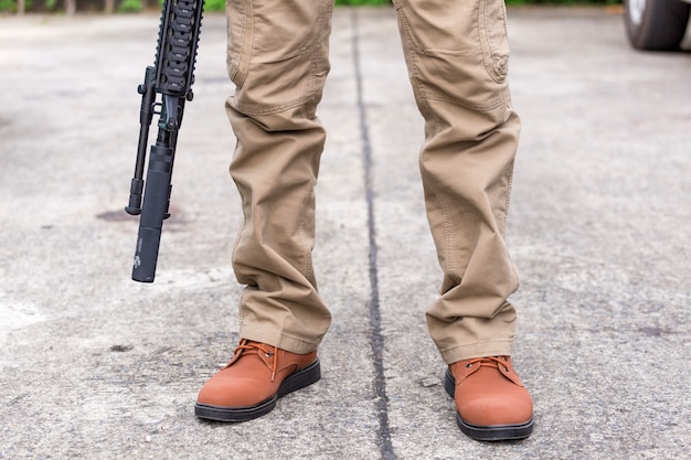 Man in cargo pants with gun