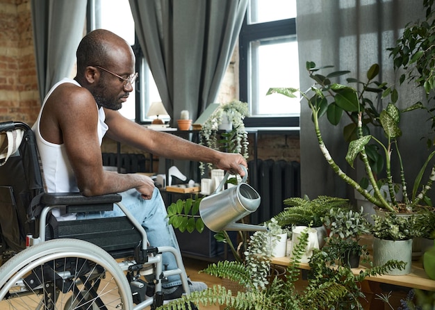 Man caring about flowers at home