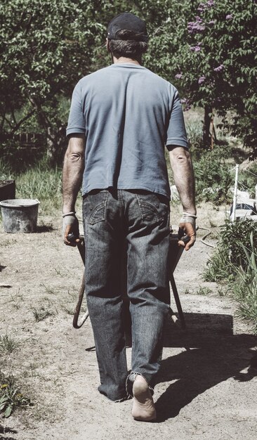 A man carries a primer in the wheelbarrow