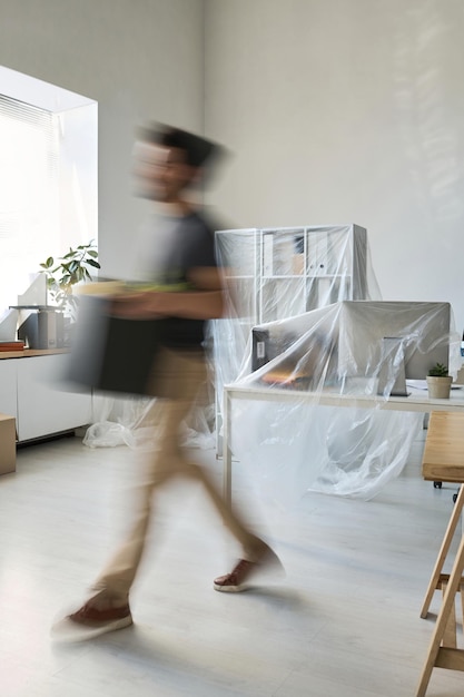 Man carrying things in box during the move
