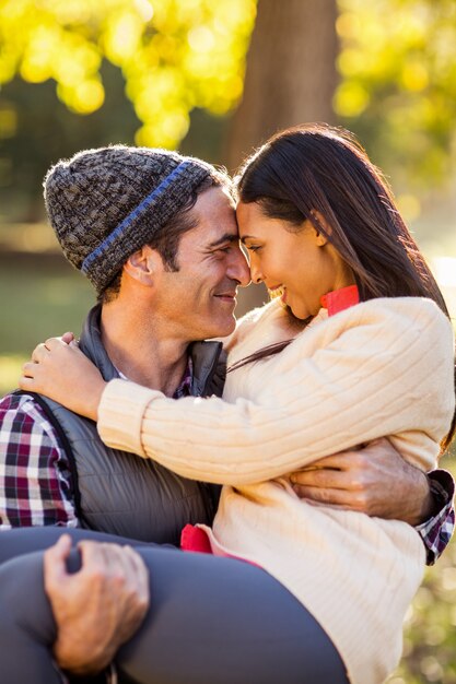 Man carrying woman at park