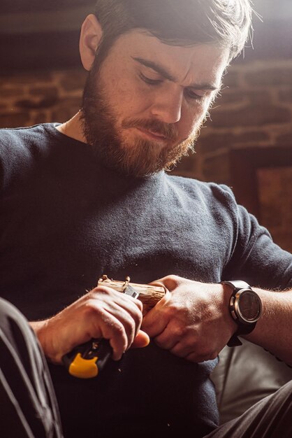 Man carving from a wooden block with a knife