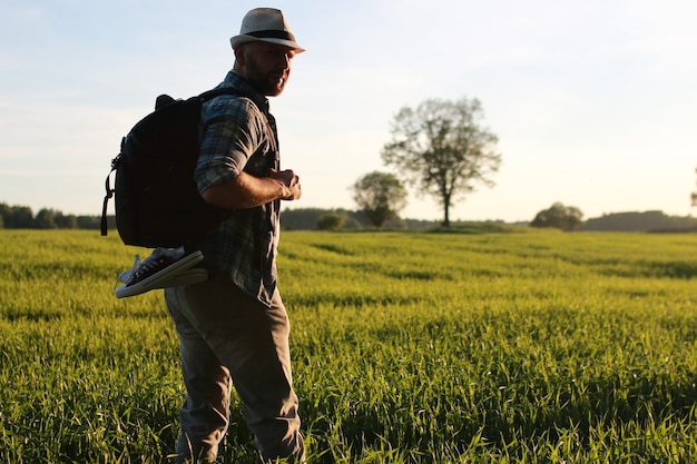 A man in casual clothes is a traveler in the open spaces