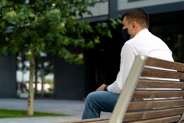 Man in casual clothes standing on a bench