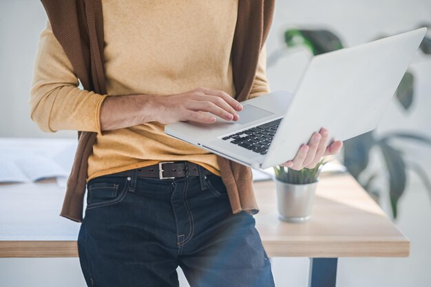 A man in casual clothes working in the office