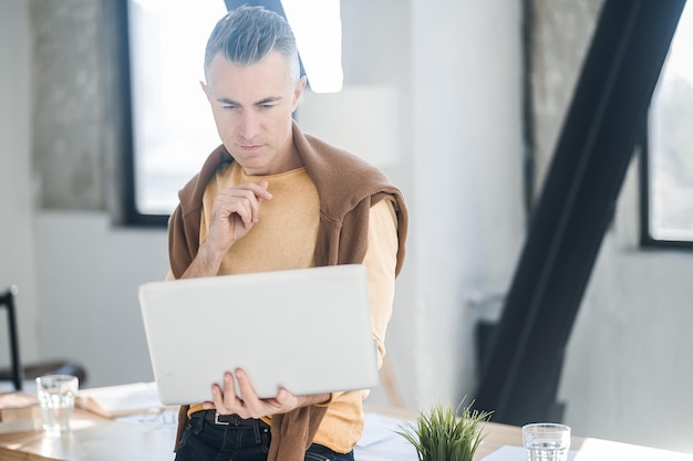 A man in casual clothes working in the office