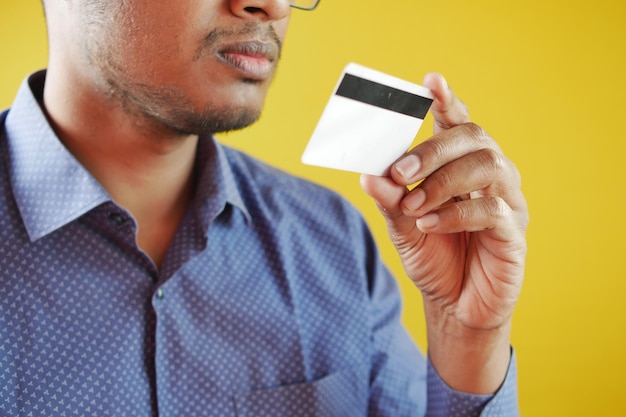 Man in casual dress showing credit card