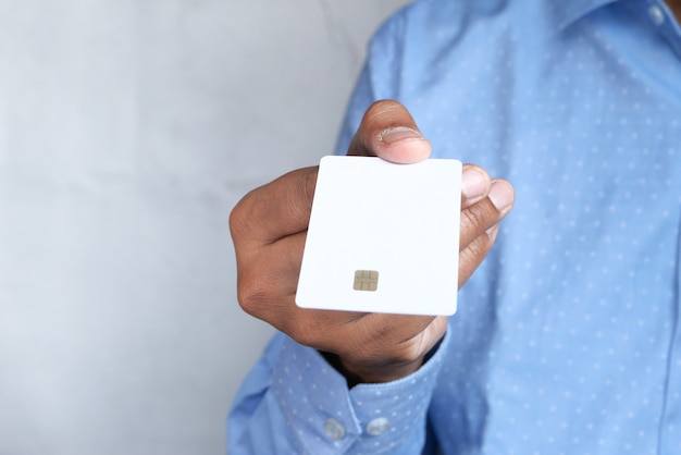 Man in casual dress showing credit card