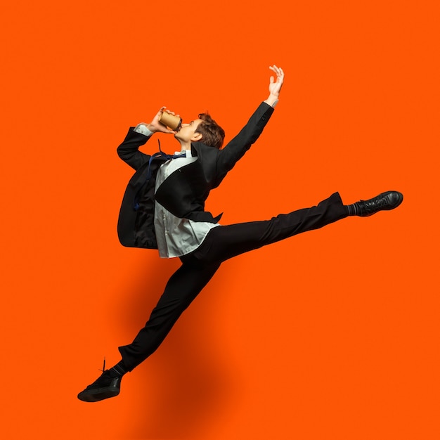 Photo man in casual office style clothes jumping isolated on studio background