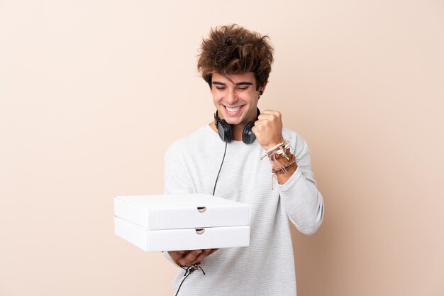 Man catching pizza boxes over isolated wall