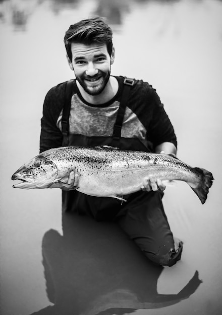 Man caught salmon fish in a river