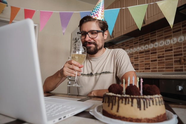 Uomo che festeggia il compleanno online in tempo di quarantena